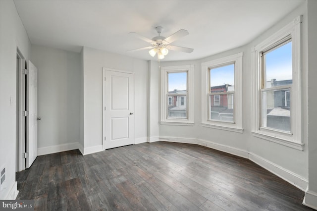 unfurnished bedroom with ceiling fan and dark wood-type flooring