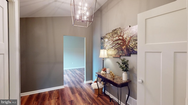 hallway with a chandelier and dark wood-type flooring