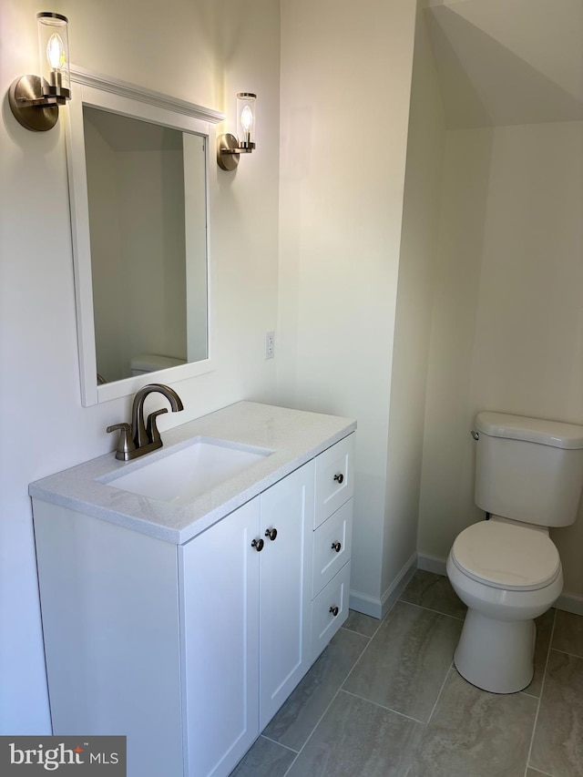 bathroom featuring vanity, toilet, and tile patterned floors