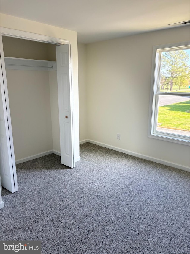 unfurnished bedroom with a closet and carpet