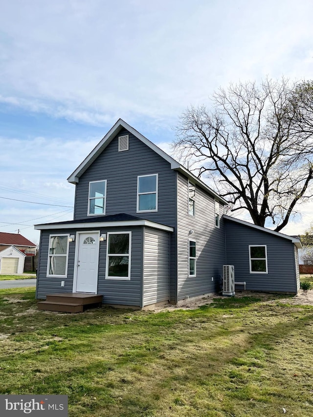 back of house featuring cooling unit and a yard