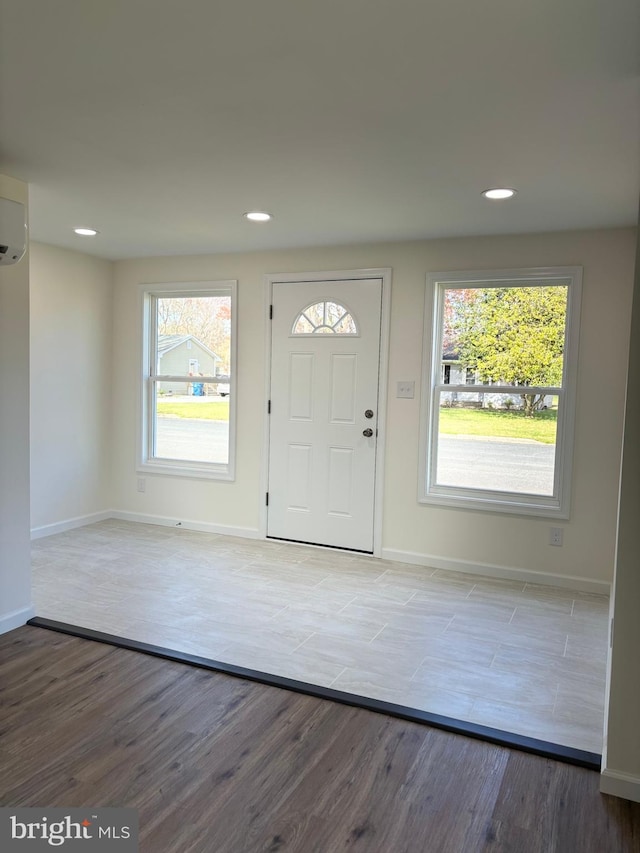 foyer entrance featuring an AC wall unit