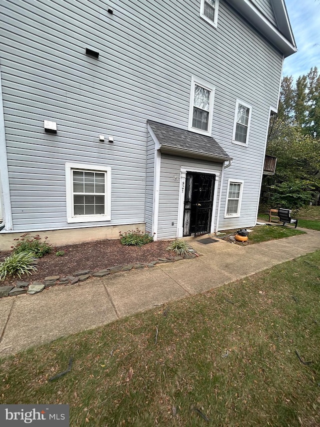 entrance to property with a patio and a yard