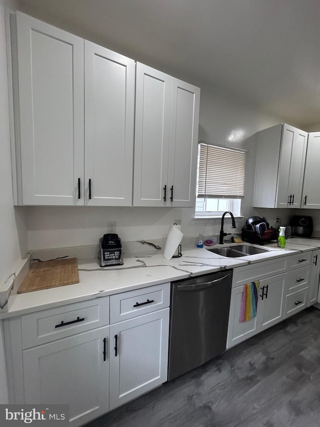 kitchen featuring light stone counters, sink, dark wood-type flooring, white cabinetry, and dishwasher