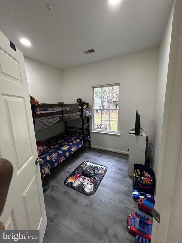 bedroom with dark hardwood / wood-style floors