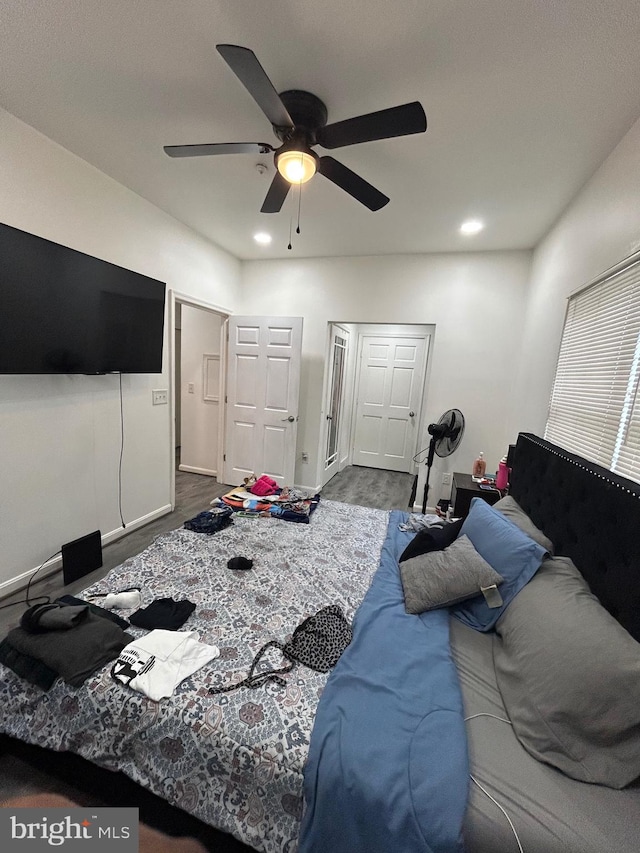 bedroom with hardwood / wood-style flooring and ceiling fan