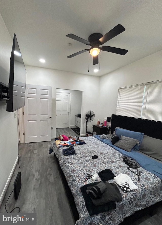 bedroom featuring baseboards, a ceiling fan, and wood finished floors