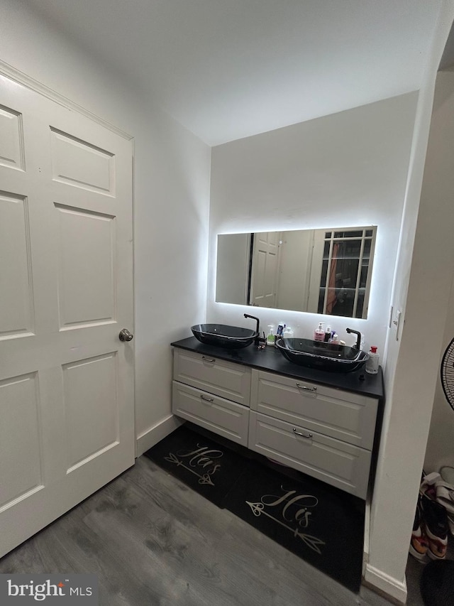 bathroom with vanity and hardwood / wood-style flooring