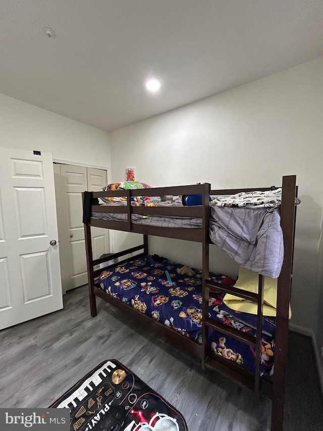 bedroom with a closet and hardwood / wood-style floors