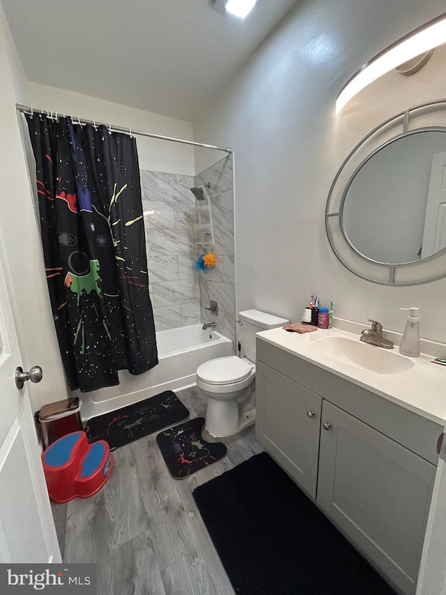 bathroom with shower / bath combination with curtain, toilet, vanity, and wood finished floors