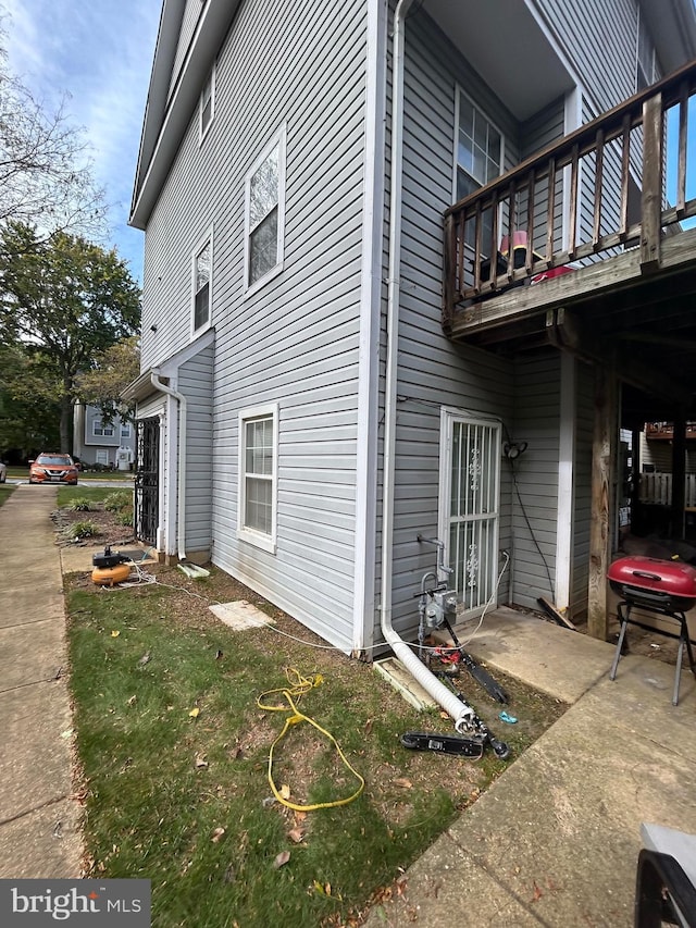 view of side of home featuring a balcony
