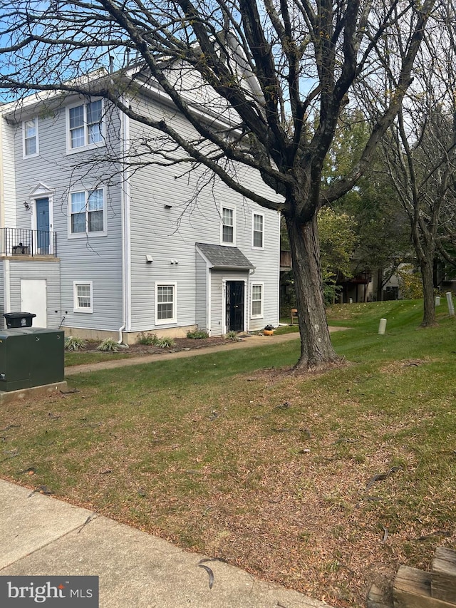 view of side of property with a yard