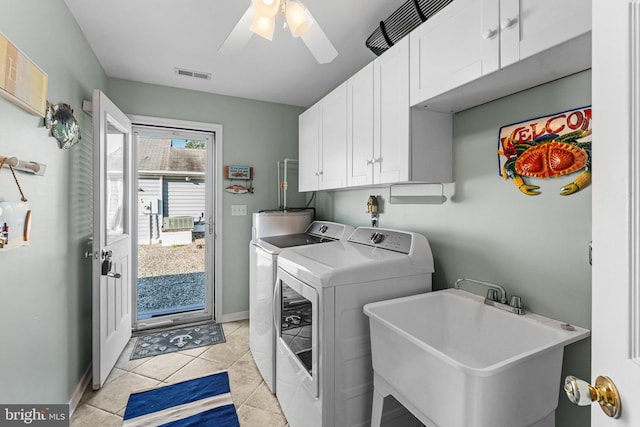 clothes washing area featuring cabinets, sink, light tile patterned floors, ceiling fan, and washing machine and dryer