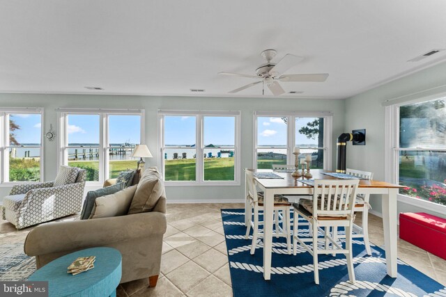 sunroom / solarium featuring ceiling fan