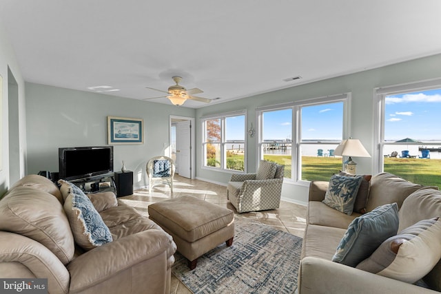 tiled living room with ceiling fan