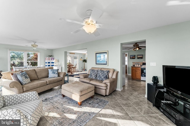 living room with tile patterned flooring and ceiling fan