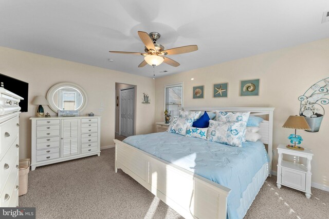 bedroom featuring ceiling fan, light colored carpet, and a closet