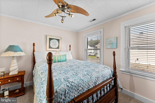 bedroom with carpet, crown molding, and ceiling fan