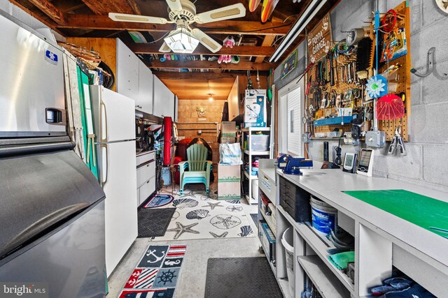 miscellaneous room featuring ceiling fan and a workshop area