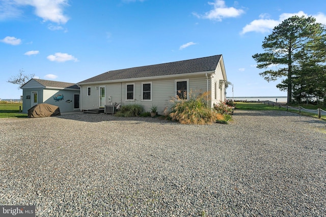 back of house featuring cooling unit