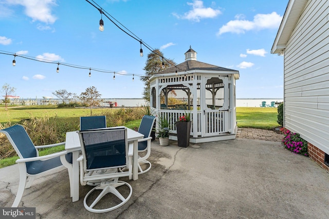 view of patio / terrace with a gazebo and a water view