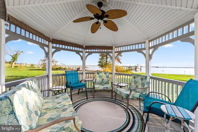 view of patio / terrace with a gazebo, a water view, and ceiling fan