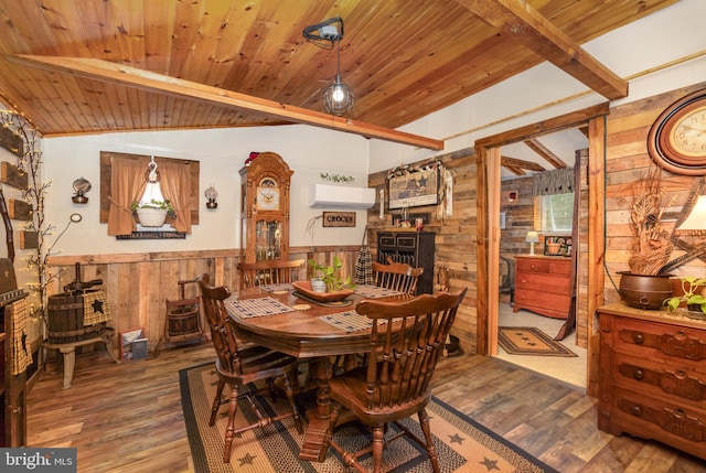 dining room featuring an AC wall unit, vaulted ceiling with beams, hardwood / wood-style floors, and wood ceiling