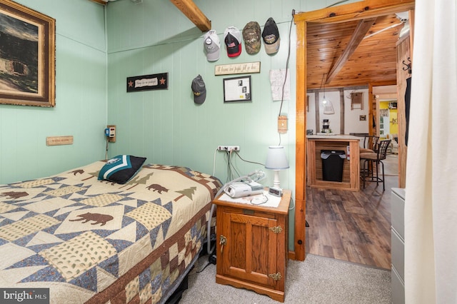 bedroom featuring wooden ceiling, hardwood / wood-style floors, and wooden walls