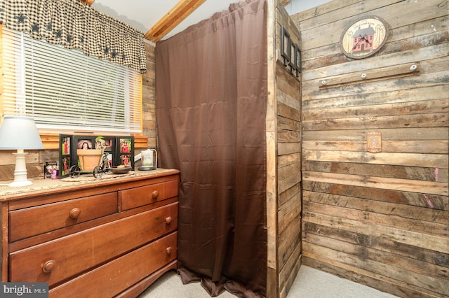 bathroom with vanity and wood walls