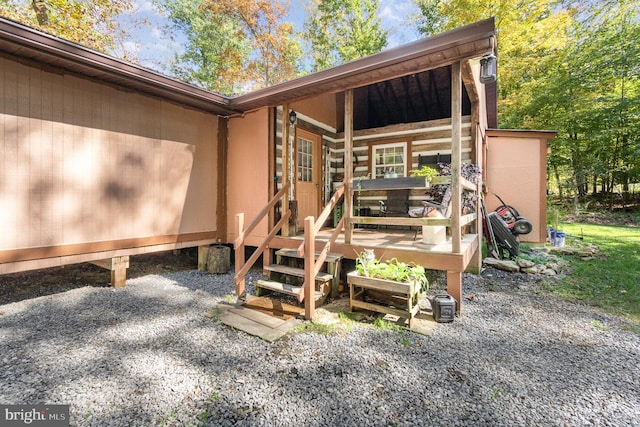 view of exterior entry with a patio