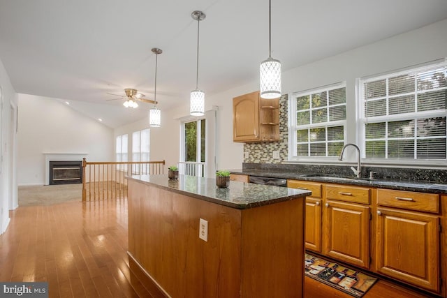 kitchen featuring a kitchen island, pendant lighting, ceiling fan, hardwood / wood-style flooring, and sink