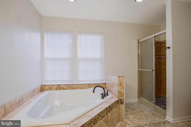 bathroom featuring tile patterned flooring and separate shower and tub