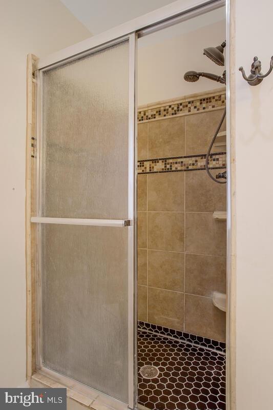 bathroom featuring a shower with shower door