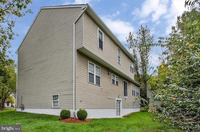 view of property exterior with a yard