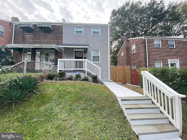 view of front of home with a front yard and a porch