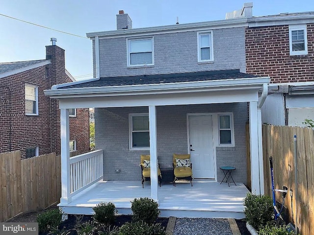 back of property featuring covered porch