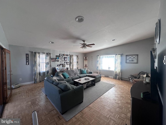 living room featuring ceiling fan, parquet floors, and lofted ceiling