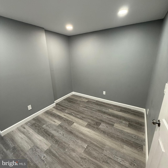 empty room with dark hardwood / wood-style flooring