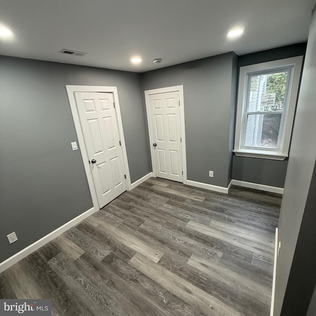 spare room with dark hardwood / wood-style floors