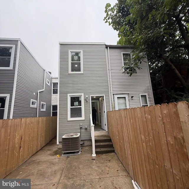 rear view of house with cooling unit and a patio area