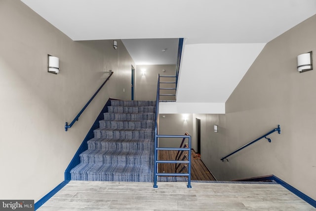 stairway with hardwood / wood-style floors