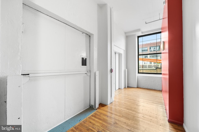 hallway with light hardwood / wood-style flooring