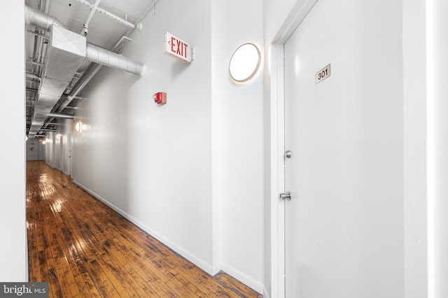 corridor with hardwood / wood-style flooring