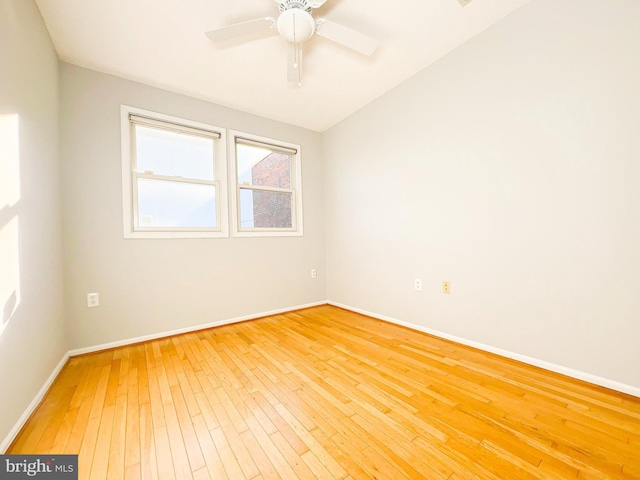 empty room with hardwood / wood-style flooring and ceiling fan