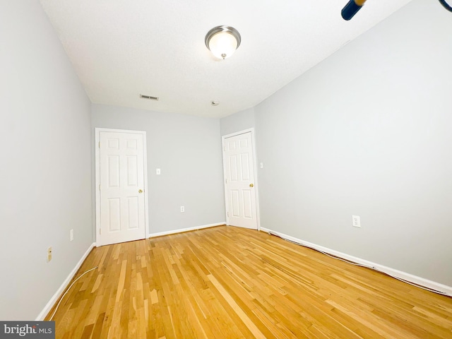 empty room with hardwood / wood-style flooring