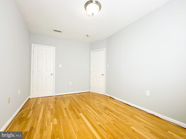 empty room featuring hardwood / wood-style flooring