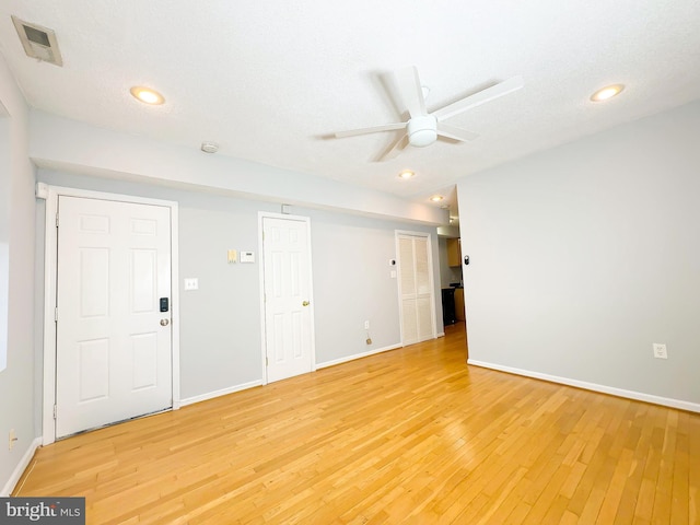 spare room with wood-type flooring, a textured ceiling, and ceiling fan