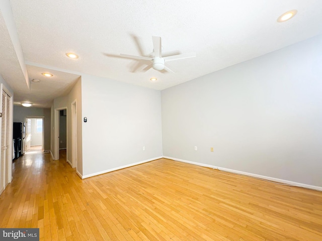 unfurnished room featuring ceiling fan, a textured ceiling, and light hardwood / wood-style floors