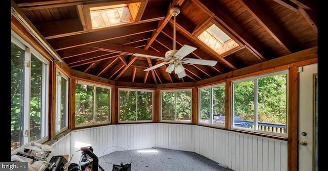 unfurnished sunroom featuring lofted ceiling with skylight and ceiling fan