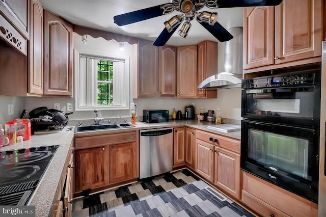 kitchen with black appliances, wall chimney exhaust hood, sink, and ceiling fan